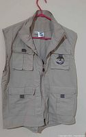 Front view of khaki photographer vest showing zipper and pockets
