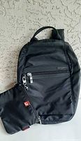 Front view of black Hedgren backpack with clutch attached