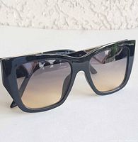 Front view of black oversized square sunglasses showing lens tint and frame shape