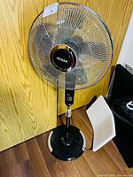 Full view of Noma pedestal fan standing on floor