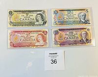 Front view of all four Canadian banknotes in sleeves