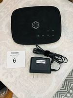 Top view of Ooma Telo with power adapter