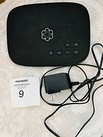 Top view of Ooma Telo base station with power adapter
