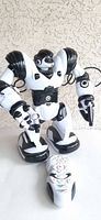 Front view of WowWee Robosapien robot standing with remote