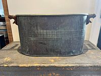 Front view of oblong copper boiler showing patina