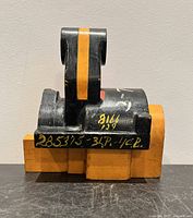 front view showing black upper portion, orange base, yellow identifiers