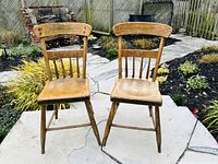 Front view of both antique pine chairs on patio