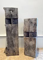 Front view of both barn beams showing height difference and weathered wood