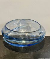 overall view of pale blue blown glass vessel showing asymmetrical slanted opening