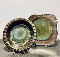 both Cynthia Cupples ceramic pieces standing on easels