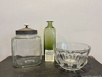 Group shot of storage jar, green bottle and pressed bowl
