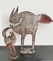 Front view of both cat sculptures displaying relative sizes and design details