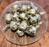 Top view of platter filled with metallic pomegranates