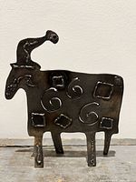 Full view of metal sheep sculpture standing