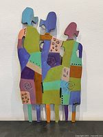 Full view of colourful three-figure metal sculpture