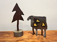 full view of both sculptures sheep and tree