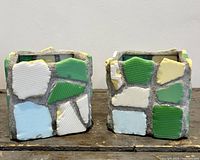 Front view of both cube planters showing mosaic glass pieces and grout