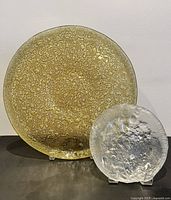 Both art glass dishes on stands showing size comparison