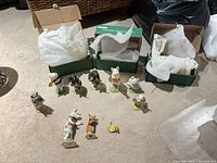 Group shot of 10 pig figurines, three Beswick boxes and loose horn
