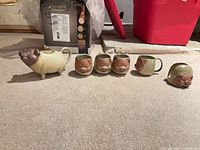 Full 6-piece pig ceramic tea set laid out