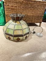 Side view of stained glass pendant showing geometric pattern and chain