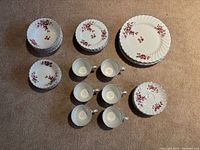 Overall view showing stacks of bowls, saucers, dinner plates, two sample plates and six teacups