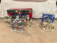 Four illuminated porcelain village buildings with boxes