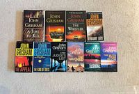 All ten John Grisham paperbacks front covers visible