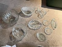 Full lot overview on carpet showing all eleven glass pieces