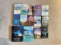 All fourteen books laid out in three rows on carpet