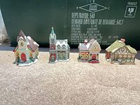 Group of four miniature Christmas village buildings