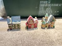 Three of the four ceramic village buildings side by side