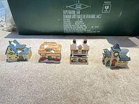 Front view of all four miniature ceramic Christmas village houses