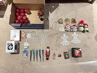 Group shot of all ornaments arranged on floor with box of apples