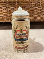 Front view showing Molson crest, wheat design and pewter lid