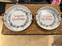 Pair of white metal trays with Seasons Greetings graphic and rope handles