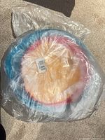 Stacked multicolor bowls sealed in original plastic bag