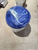 Factory-wrapped nested canister set showing blue lids