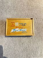 Top of wooden lid showing product title and markings