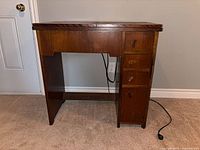 Closed wooden sewing cabinet front view