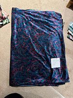 Folded velvet fabric showing pattern and attached note with dimensions