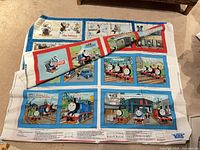 Full panel showing Thomas the Tank Engine and The Mitten page layouts