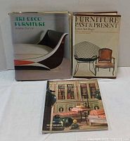 Front view of three furniture reference books standing upright