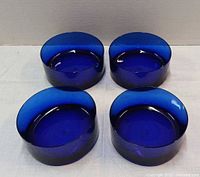 Top view of four cobalt blue glass snack bowls