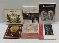 Front view of all six books laid out