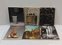 Front covers of all six Sotheby’s catalogues displayed upright