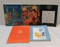 Front covers of five of the six books showing titles and artwork