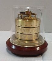 Oblique view of brass weather station under acrylic dome