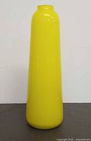 Full front view of yellow art glass vase standing upright