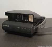 Polaroid Spectra AF camera open showing lens and flash